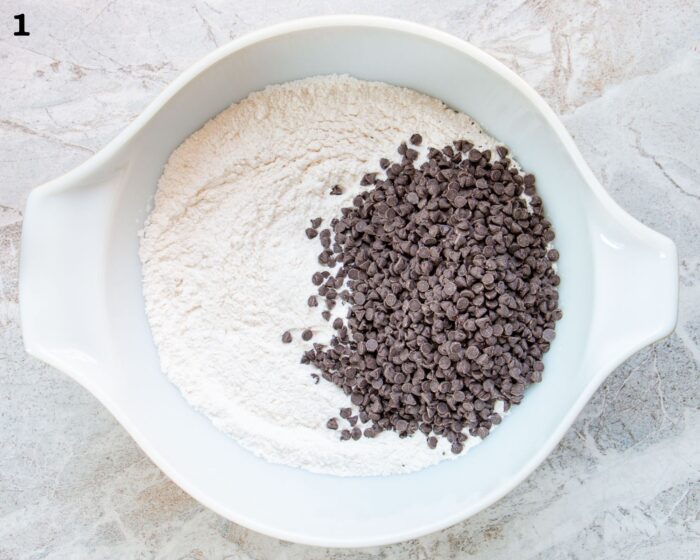 A bowl of dry ingredients and chocolate chips to make muffins.