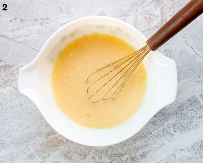 A bowl of wet ingredients for a muffin batter.
