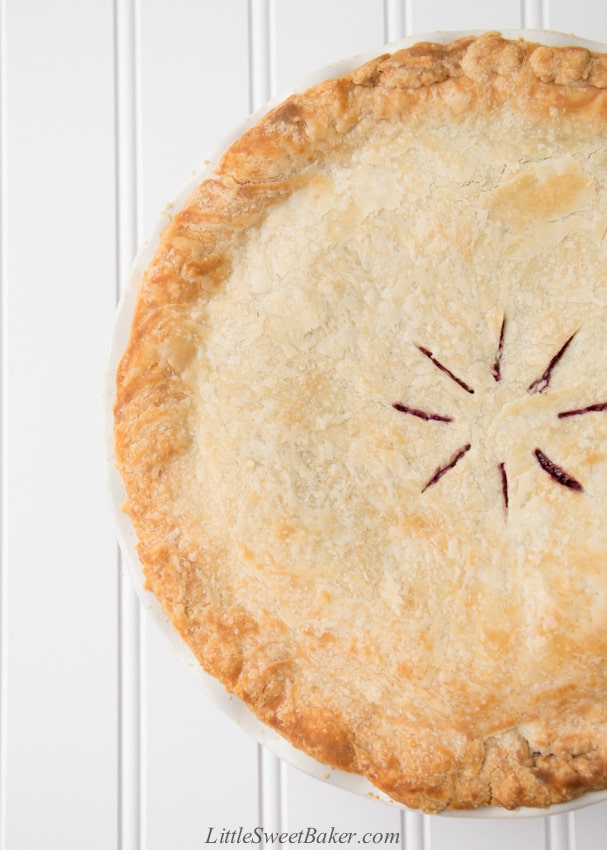 A top view of a oil pie crust pie on a white background.