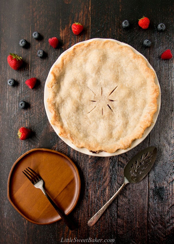 A mixed berry pie on a wooden table.