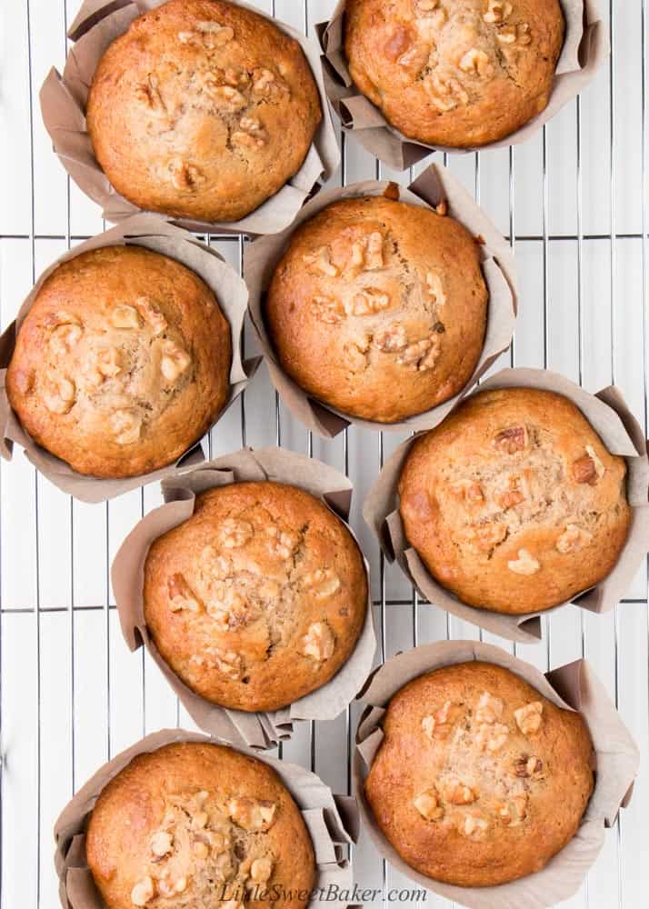 An overtop view of bakery style banana nut muffins on a cooling rack.