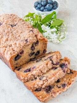 This is a moist flavorful banana bread, studded with delicious blueberries, topped with a crunchy sweet cinnamon streusel, and made without eggs. (video recipe)