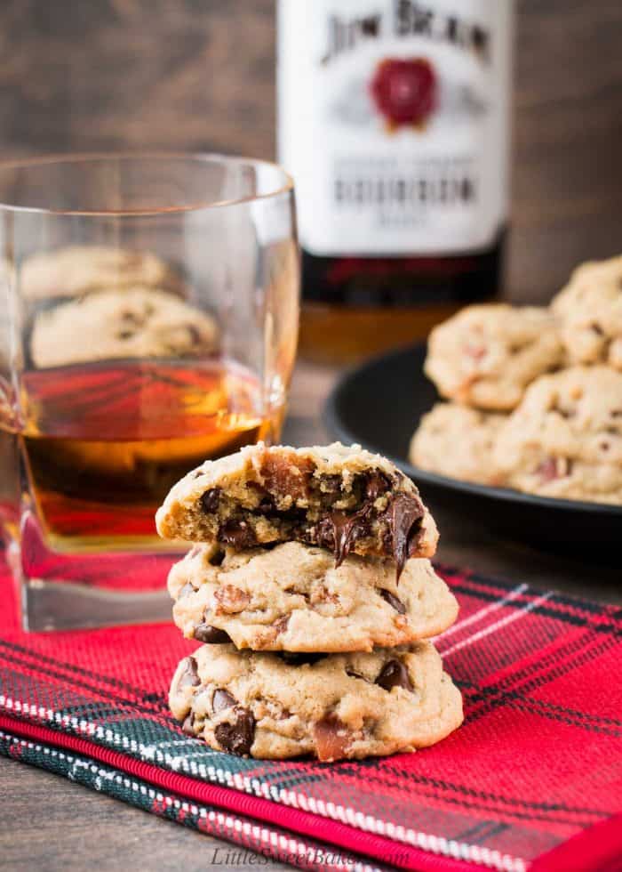 A stake of bourbon bacon chocolate chip cookies on a red napkin.