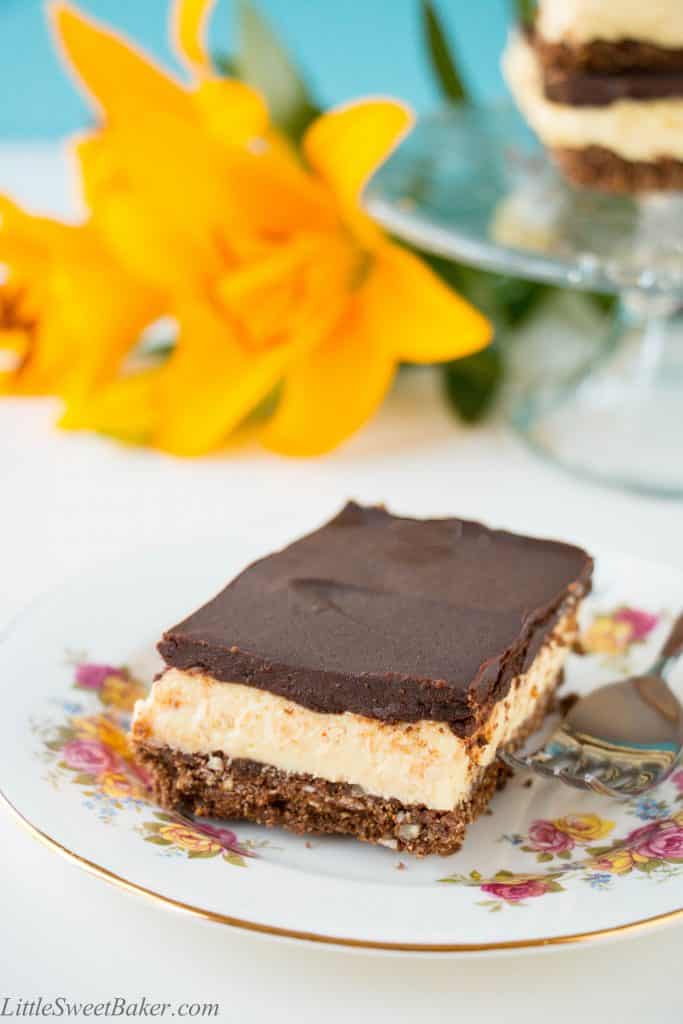 A creamy layer of vanilla custard flavored cheesecake sandwiched between a chocolatey coconut cookie crumb base and semi-sweet chocolate ganache. A twist to one of Canada's best known desserts. {Video Recipe}