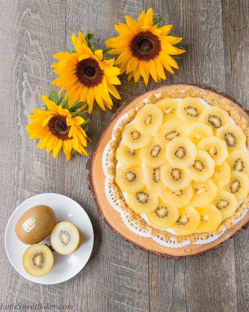 A coconut graham cracker crust topped with Greek yogurt and delicious ripe golden kiwifruit. This no-bake dessert is tasty, healthy and easy to make. {Video Recipe} #Zespri4Life #Sponsored