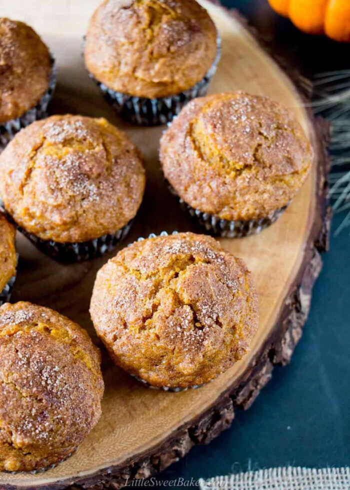 Cinnamon sugar pumpkin muffins on a wooden board.