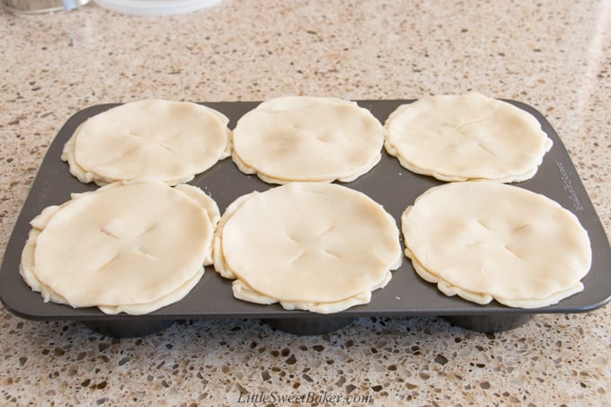 Raw mini turkey pot pies in a jumbo baking pan.