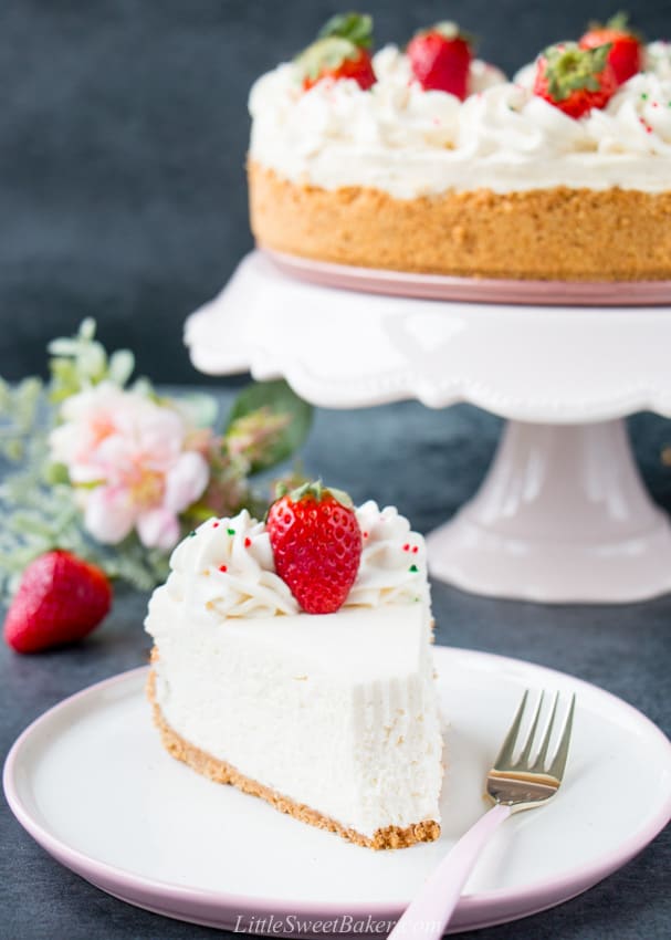 A slice of no-bake cheesecake on a pink and white plate with pink fork.