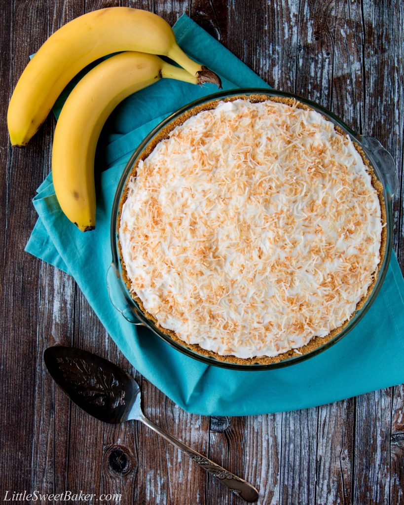 This amazing banana cream pie is made with a rich velvety-smooth homemade custard and it's lined with a honey graham cracker crust. Filled with delicious sweet slices of bananas and topped with fluffy whipped cream - it'a absolutely pie heaven! banana cream pie | best banana cream pie | easy banana cream pie | old-fashioned banana cream pie | homemade custard | coconut banana cream pie | graham cracker crust