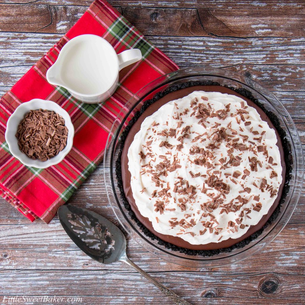 This chocolate pudding pie is made with a rich and silky homemade pudding over a chocolate cookie crust. It's topped with billowy clouds of whipped cream and sprinkled with chocolate shavings. #chocolatepuddingpie #easychocolatepuddingpie #bestchocolatepuddingpie #Thanksgivingdesserts #AD #milkcalendar