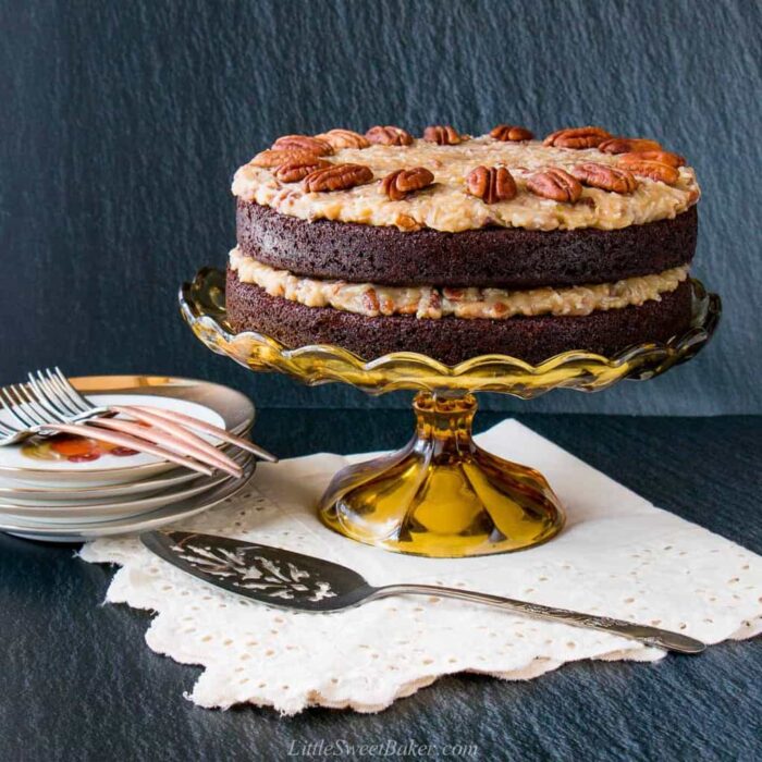 A German chocolate cake on a vintage cake stand.