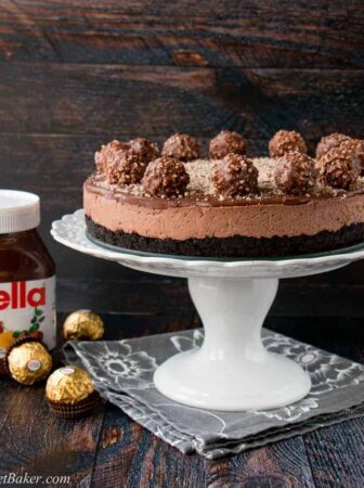 Oreo cookie crust with a Nutella cheesecake filling, topped with more Nutella and decorated with Ferrero Rocher candies. This no-bake recipe is the easiest and most delicious Nutella cheesecake you will ever make!