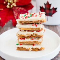 Light and crispy saltine crackers surrounded by a buttery toffee and topped with creamy white chocolate makes this little treat absolutely addictive! You won't be able to just one. #whitechocolate #christmascrack #crackcandy #christmastoffee #saltinetoffee #saltinecrackertoffee