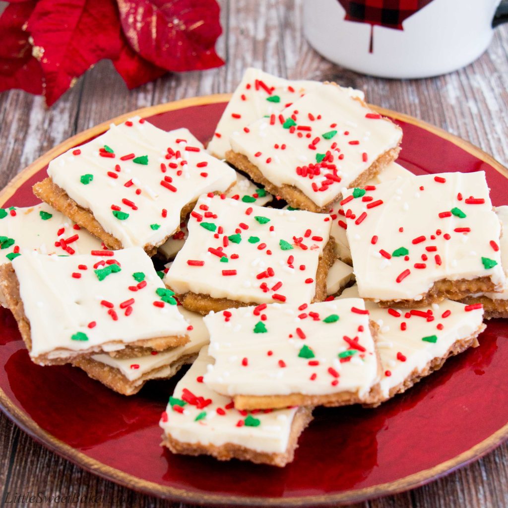 Light and crispy saltine crackers surrounded by a buttery toffee and topped with creamy white chocolate makes this little treat absolutely addictive! You won't be able to just have one. #whitechocolate #christmascrack #crackcandy #christmastoffee #saltinetoffee #saltinecrackertoffee