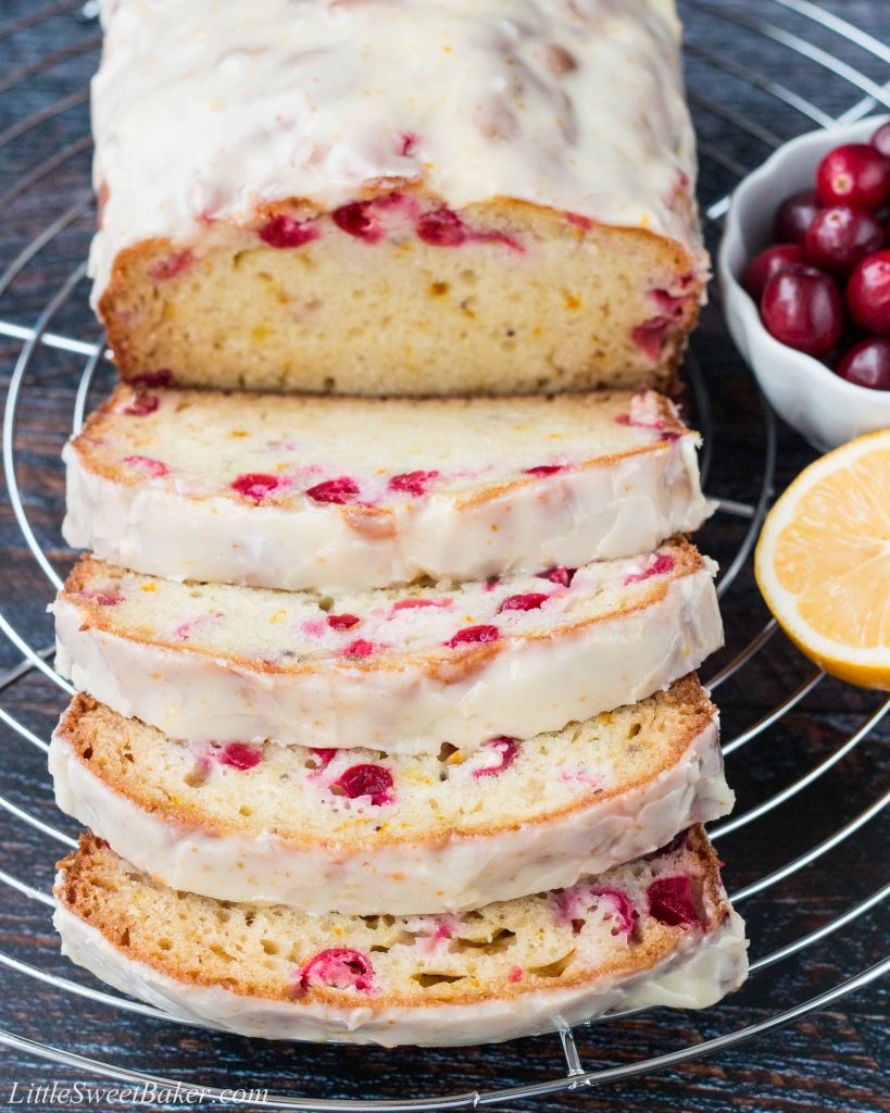 A soft and moist citrus flavored bread dotted with bright tart cranberries and topped with a sweet vibrant glaze! #cranberrybread #cranberryorangebread #orangebread #cranberrysweetbread