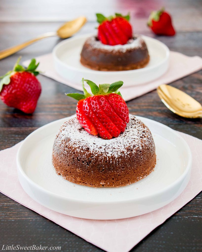 This rich and dense chocolate cake has an irresistible warm and gooey chocolate center that flows like lava when you break into the cake. Just a few simple ingredients and you can have this decadent dessert ready in under 30 minutes. #chocolatelavacake #chocolatemoltencake #moltenlavacake #valentinesdessert