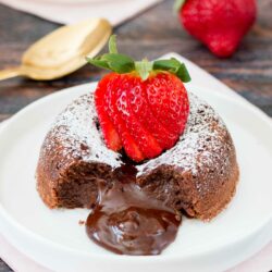 This rich and dense chocolate cake has an irresistible warm and gooey chocolate center that flows like lava when you break into the cake. Just a few simple ingredients and you can have this decadent dessert ready in under 30 minutes. #chocolatelavacake #chocolatemoltencake #moltenlavacake #valentinesdessert