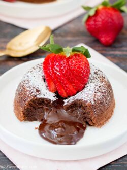 This rich and dense chocolate cake has an irresistible warm and gooey chocolate center that flows like lava when you break into the cake. Just a few simple ingredients and you can have this decadent dessert ready in under 30 minutes. #chocolatelavacake #chocolatemoltencake #moltenlavacake #valentinesdessert