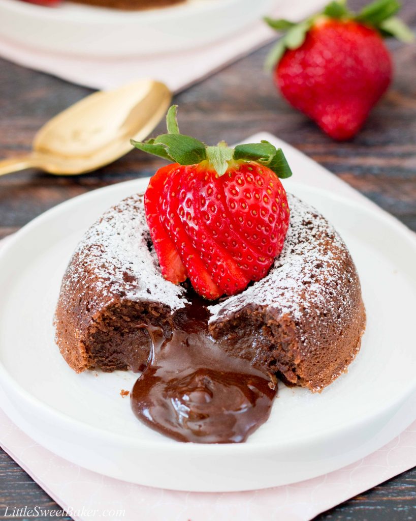 This rich and dense chocolate cake has an irresistible warm and gooey chocolate center that flows like lava when you break into the cake. Just a few simple ingredients and you can have this decadent dessert ready in under 30 minutes. #chocolatelavacake #chocolatemoltencake #moltenlavacake #valentinesdessert