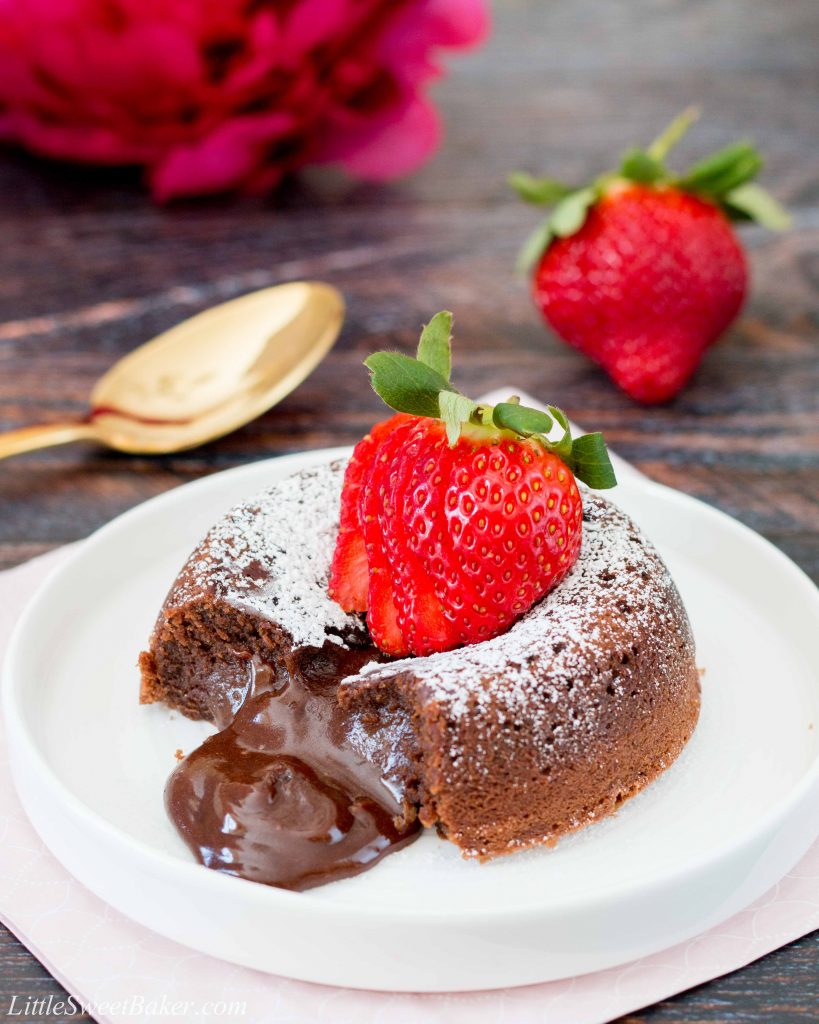 This rich and dense chocolate cake has an irresistible warm and gooey chocolate center that flows like lava when you break into the cake. Just a few simple ingredients and you can have this decadent dessert ready in under 30 minutes. #chocolatelavacake #chocolatemoltencake #moltenlavacake #valentinesdessert