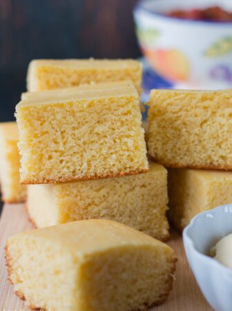 This moist, fluffy and tender cornbread is a perfect addition to any meal. This quick and easy recipe can be prepared, baked and ready to serve in under 30 minutes. #cornbreadrecipe #sweetcornbread #buttermilkcornbread #southerncornbread #easycornbread