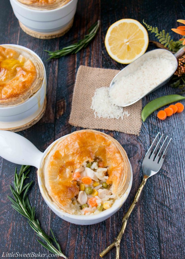 These mini chicken pot pies are topped with a flaky puff pastry and filled with rice, veggies and chicken in a creamy lemon sauce. #chickenpotpie #minichickenpotpies #chickenandrice #ReachForRice #Ad #usaricecan
