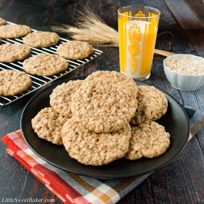 A plate of oatmeal cookies with a glass of milk.