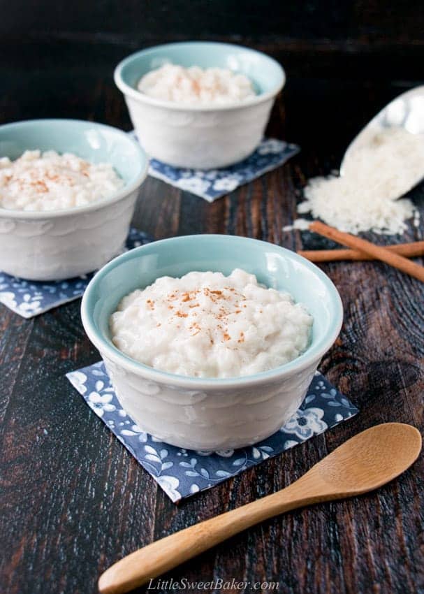 three bowls of rice pudding on small blue napkins