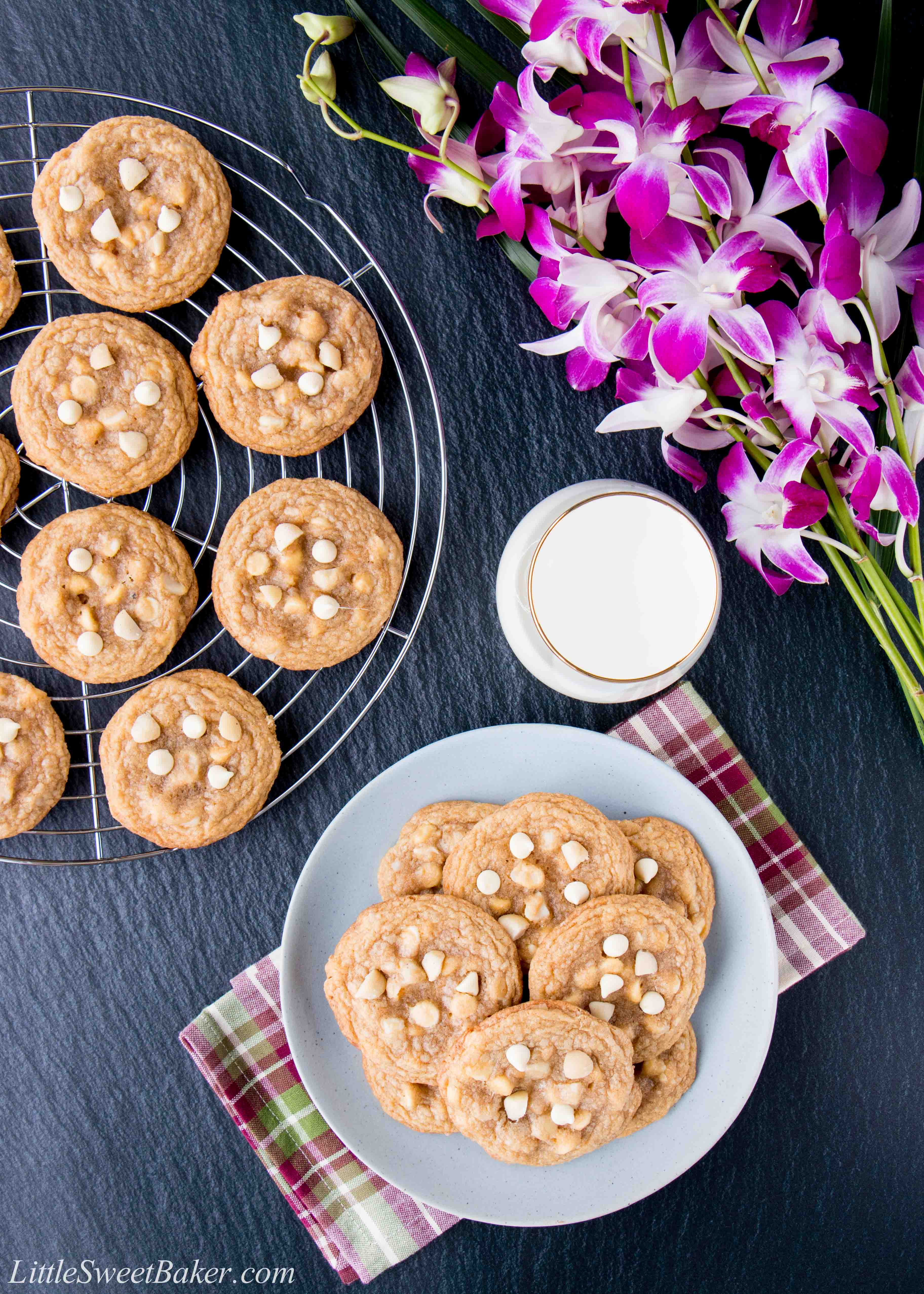 White chocolate macadamia nut cookies on a cooling rack and blue plate.
