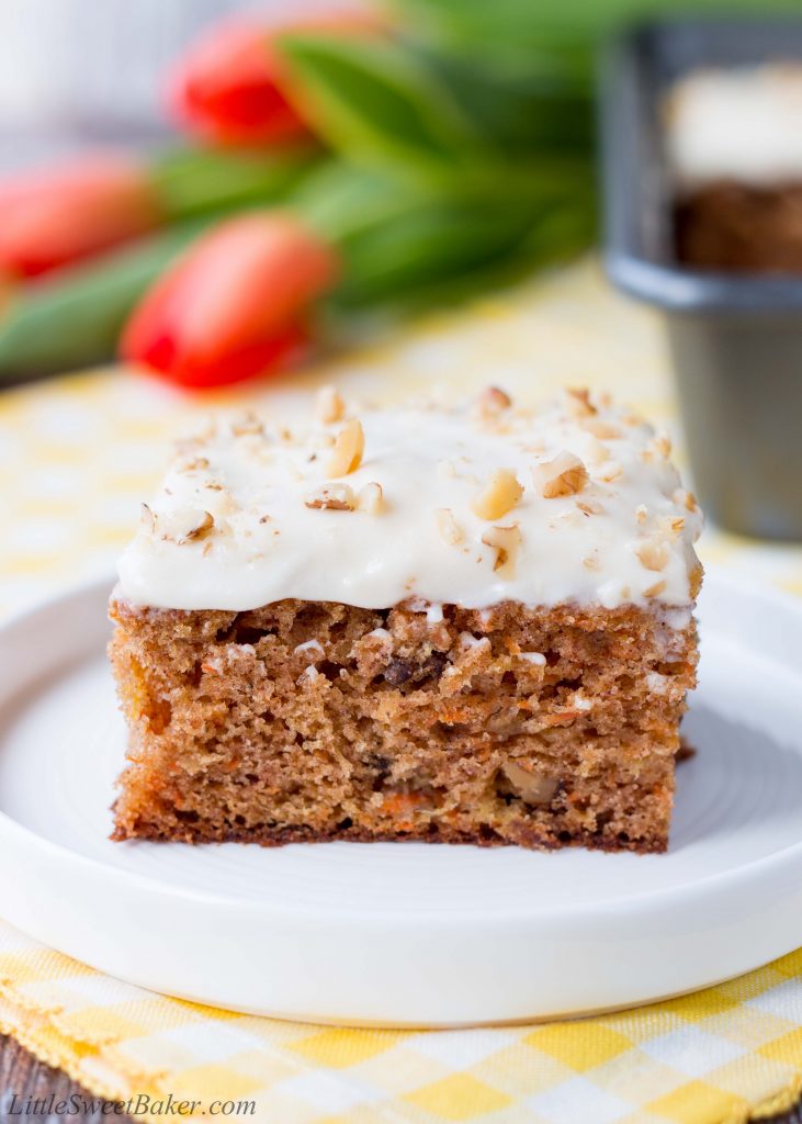 This delicious carrot cake is easy to make, moist and tender. It's speckled with shredded carrots, pineapple chunks, walnuts and topped with a sweet-tangy cream cheese frosting. #carrotcake #carrotcakerecipe #easycarrotcake