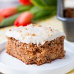 This delicious carrot cake is easy to make, moist and tender. It's speckled with shredded carrots, pineapple chunks, walnuts and topped with a sweet-tangy cream cheese frosting. #carrotcake #carrotcakerecipe #easycarrotcake