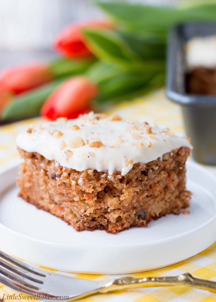 This delicious carrot cake is easy to make, moist and tender. It's speckled with shredded carrots, pineapple chunks, walnuts and topped with a sweet-tangy cream cheese frosting. #carrotcake #carrotcakerecipe #easycarrotcake