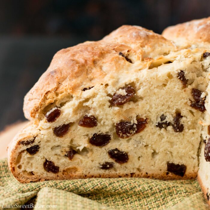 A close-up of a loaf of soda bread with raisins to show the texture inside.