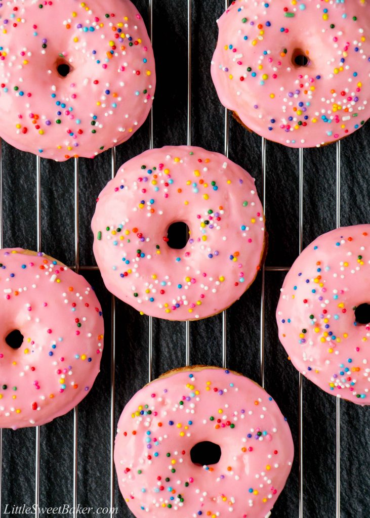 These baked donuts are soft, fluffy, and so much healthier than fried donuts, but just as tasty! #vanilladonuts #bakeddonuts #homemadedonuts #vanillaglaze #glazeddonuts