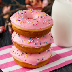 These baked donuts are soft, fluffy, and so much healthier than fried donuts, but just as tasty! #vanilladonuts #bakeddonuts #homemadedonuts #vanillaglaze #glazeddonuts