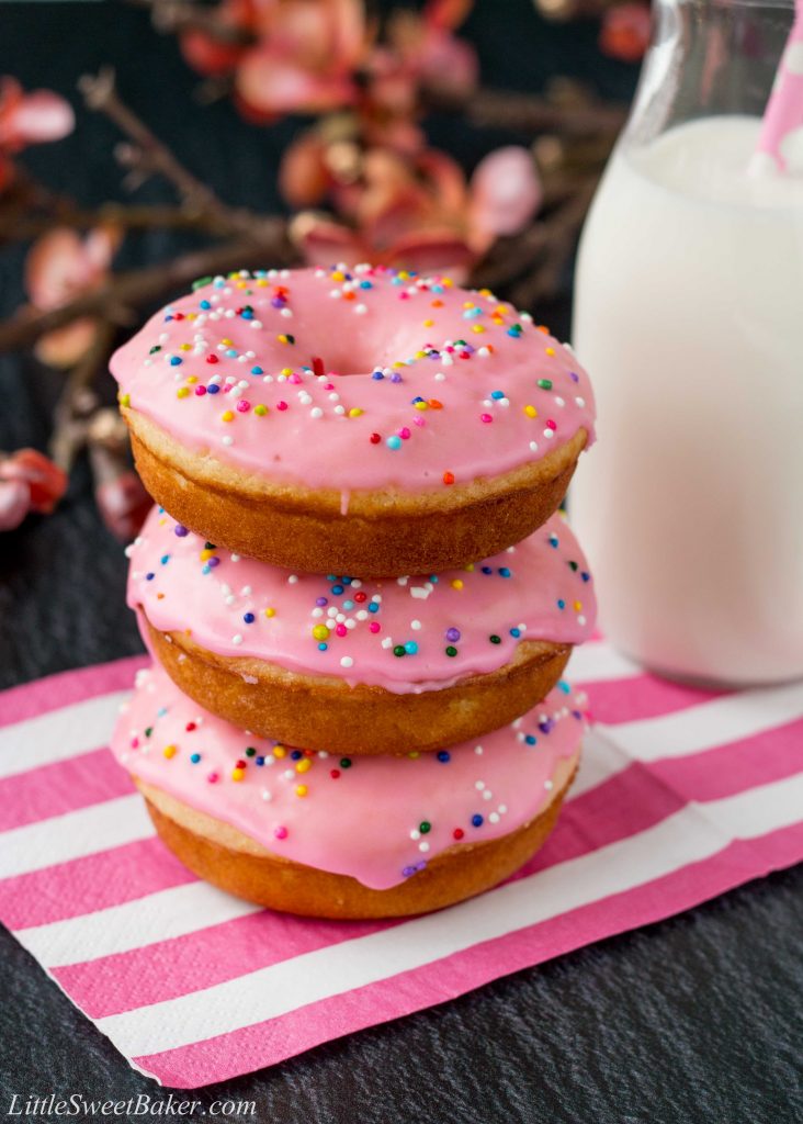 These baked donuts are soft, fluffy, and so much healthier than fried donuts, but just as tasty! #vanilladonuts #bakeddonuts #homemadedonuts #vanillaglaze #glazeddonuts