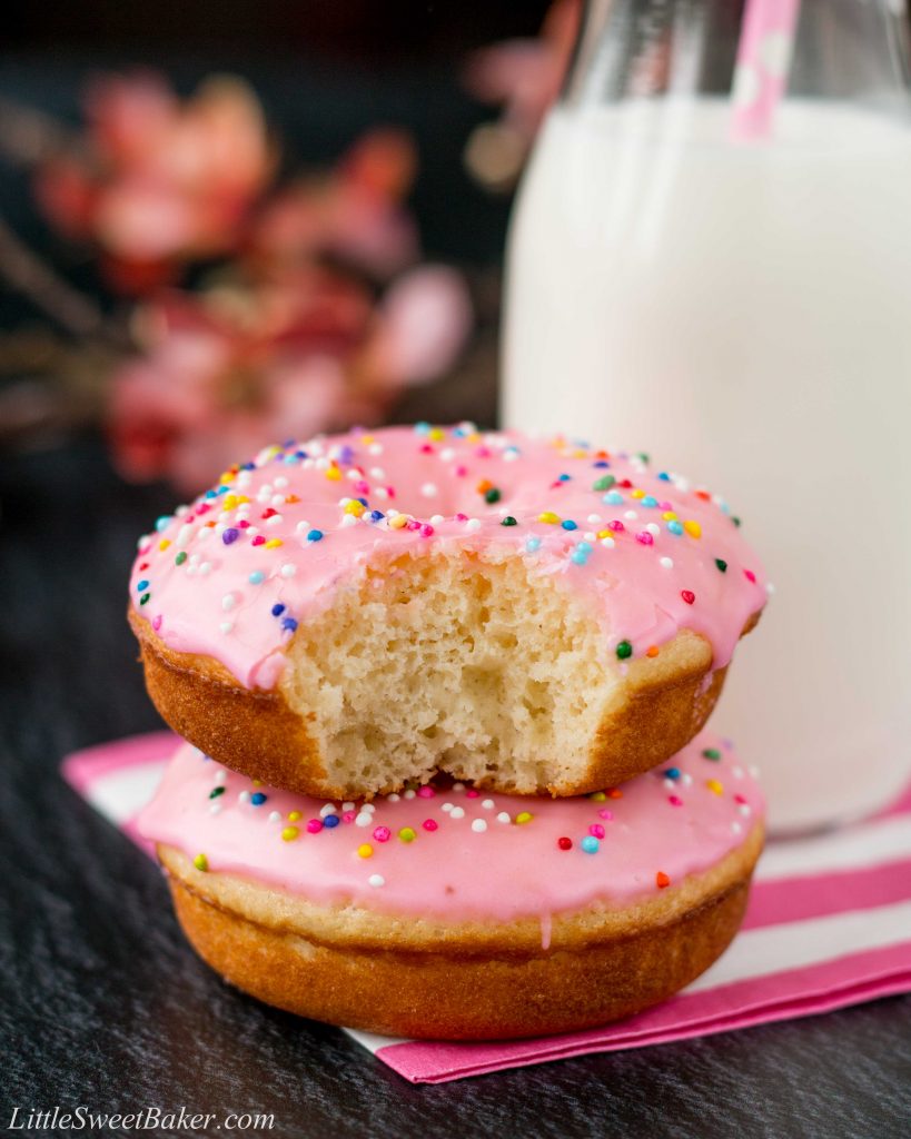 These baked donuts are soft, fluffy, and so much healthier than fried donuts, but just as tasty! #vanilladonuts #bakeddonuts #homemadedonuts #vanillaglaze #glazeddonuts