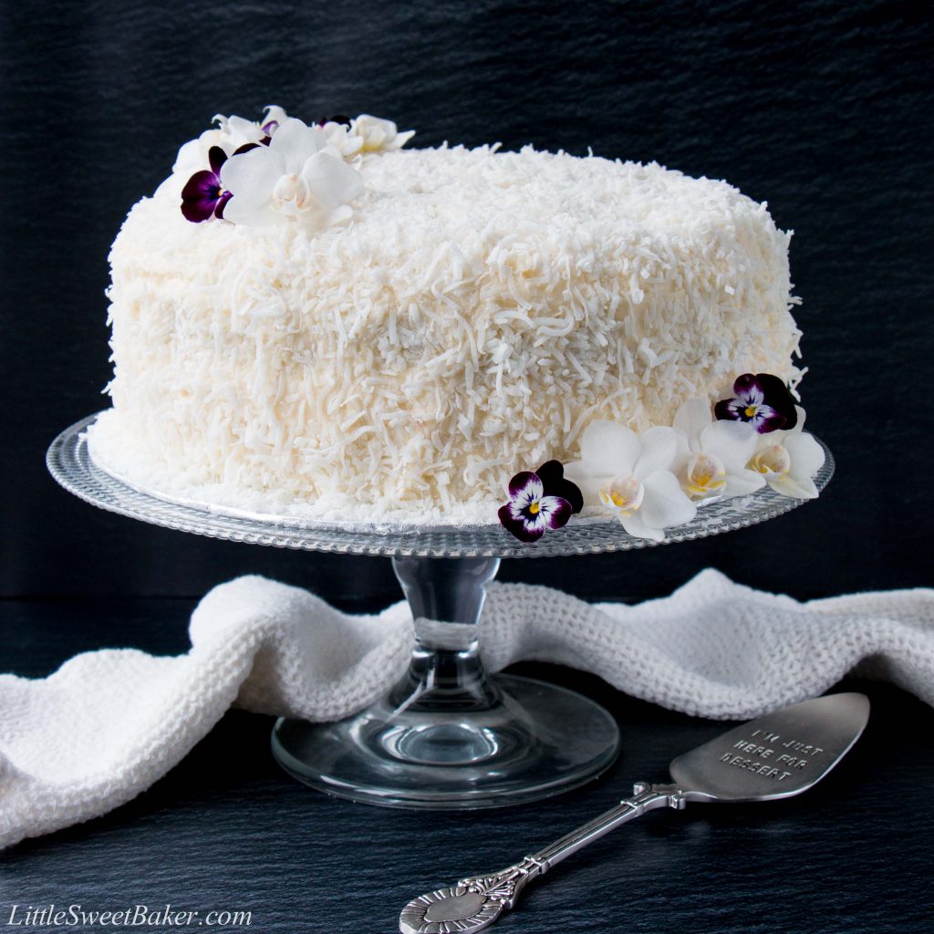This delicious made-from-scratch coconut cake is infused with natural coconut flavor and topped with a sweet-tangy cream cheese frosting. #coconutcake #southerncoconutcake #bestcoconutcake #inagartencoconutcake #easycoconutcake #easterdessert