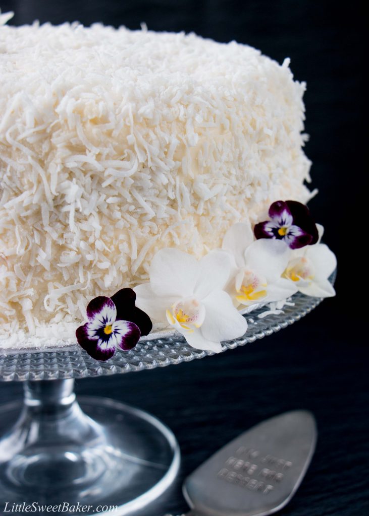 This delicious made-from-scratch coconut cake is infused with natural coconut flavor and topped with a sweet-tangy cream cheese frosting. #coconutcake #southerncoconutcake #bestcoconutcake #inagartencoconutcake #easycoconutcake #easterdessert