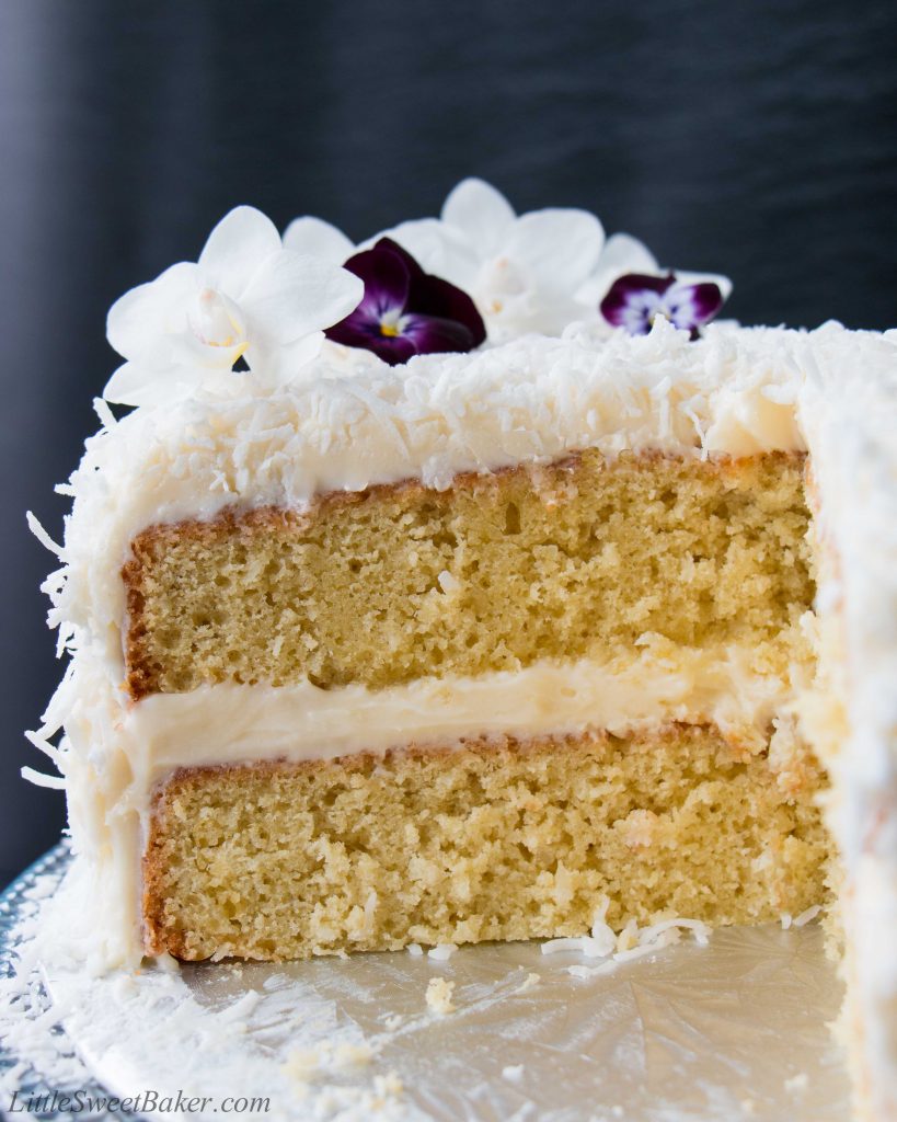 This delicious made-from-scratch coconut cake is infused with natural coconut flavor and topped with a sweet-tangy cream cheese frosting. #coconutcake #southerncoconutcake #bestcoconutcake #inagartencoconutcake #easycoconutcake #easterdessert