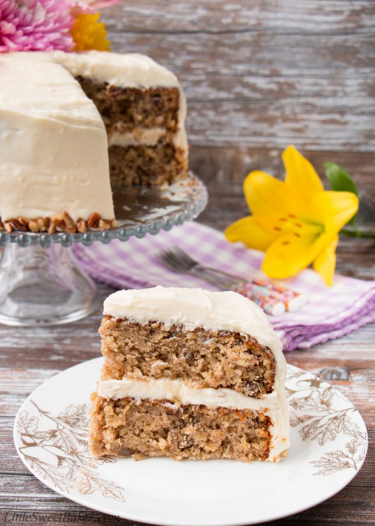 Coated in a delicious cream cheese frosting, this supremely moist banana cake has sweet pieces of pineapples and crunchy pecans mixed in. It's spiced with cinnamon and nutmeg, and sweetened with brown sugar. #hummingbirdcake #layercake #creamcheesefrosting #bananacake