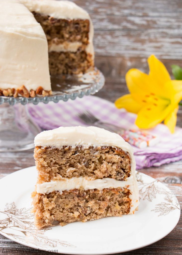 Coated in a delicious cream cheese frosting, this supremely moist banana cake has sweet pieces of pineapples and crunchy pecans mixed in. It's spiced with cinnamon and nutmeg, and sweetened with brown sugar. #hummingbirdcake #layercake #creamcheesefrosting #bananacake