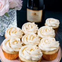 These cupcakes are rich, moist and full of champagne flavor. They are topped with a sweet and tangy champagne buttercream, and some gold sprinkles to make them extra special! #champagnecupcakes #champagnefrosting #mothersday #newyearseve #recipe #dessert