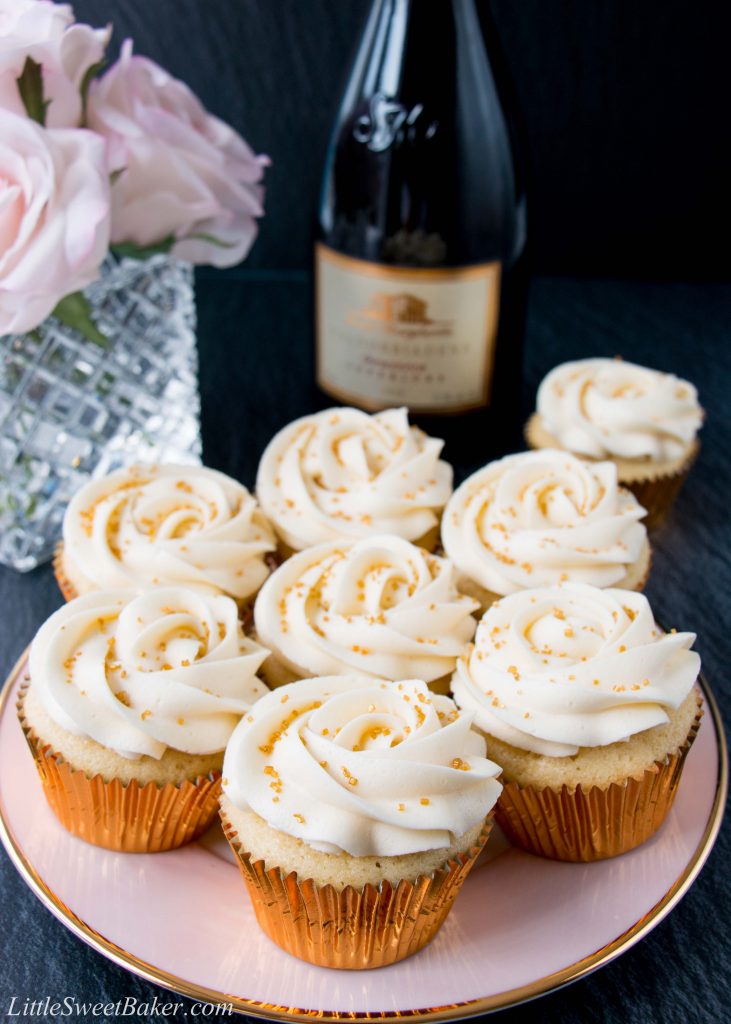 These cupcakes are rich, moist and full of champagne flavor. They are topped with a sweet and tangy champagne buttercream, and some gold sprinkles to make them extra special! #champagnecupcakes #champagnefrosting #mothersday #newyearseve #recipe #dessert