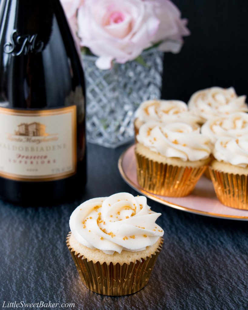 These cupcakes are rich, moist and full of champagne flavor. They are topped with a sweet and tangy champagne buttercream, and some gold sprinkles to make them extra special! #champagnecupcakes #champagnefrosting #mothersday #newyearseve #recipe #dessert