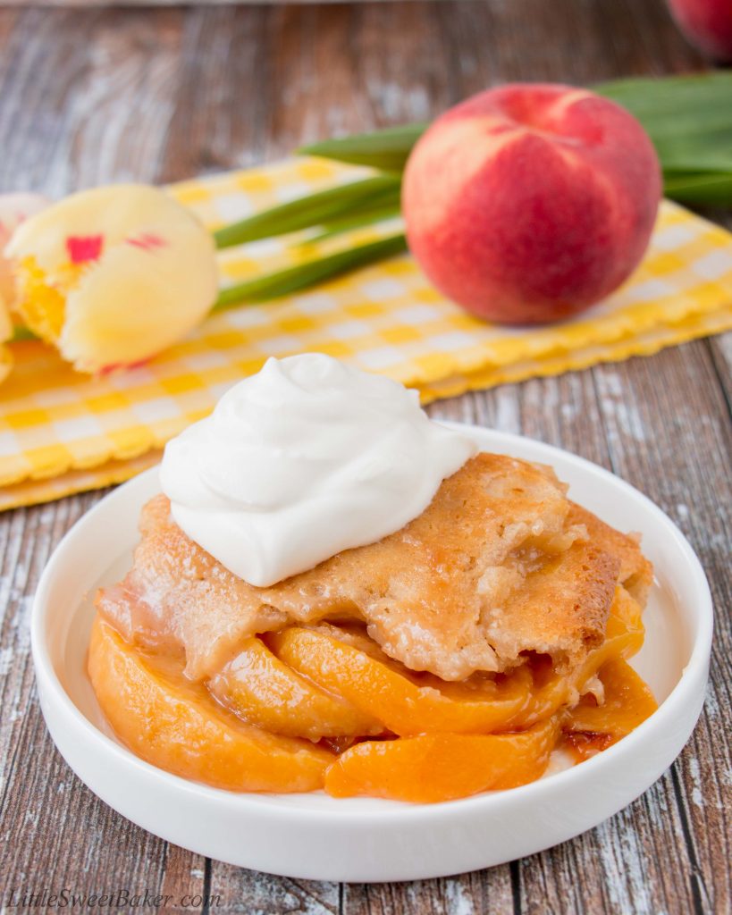 This heavenly peach cobbler consists of juicy flavorful peaches baked underneath a soft and fluffy cake topping. You can enjoy this made-from-scratch recipe all year round by using fresh, canned or even frozen peaches! #peachcobbler #easypeachcobbler #southernpeachcobbler