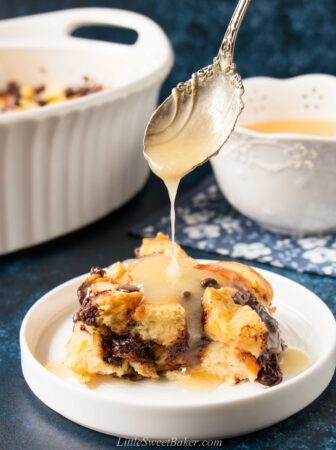 This classic recipe is elevated with the addition of chocolate and rich-buttery brioche bread. #breadpudding #chocolatechipbreadpudding #bourbonsauce #whiskeysauce #NewOrleansstyle
