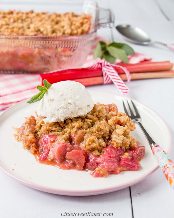 A plate of rhubarb crisp topped with ice cream.