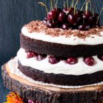 Easy Homemade Black Forest Cake - moist decadent chocolate cake surrounded by whipped cream and juicy black cherries. #blackforestcake #easyblackforestcake #blackforestgateau