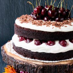 Easy Homemade Black Forest Cake - moist decadent chocolate cake surrounded by whipped cream and juicy black cherries. #blackforestcake #easyblackforestcake #blackforestgateau